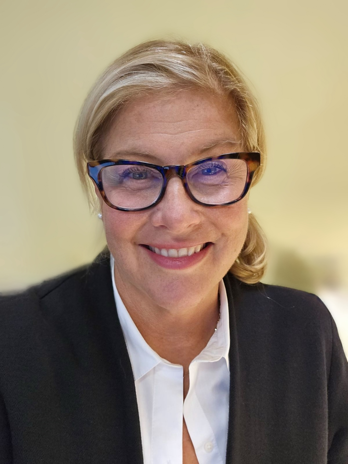 Hilary Noren Hilary Noren, wearing a black suit jacket and white collared shirt